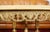 Heavy metal tripod base with floral decoration. Top onyx natural stone top has a cut edge. Richly decorated base....
