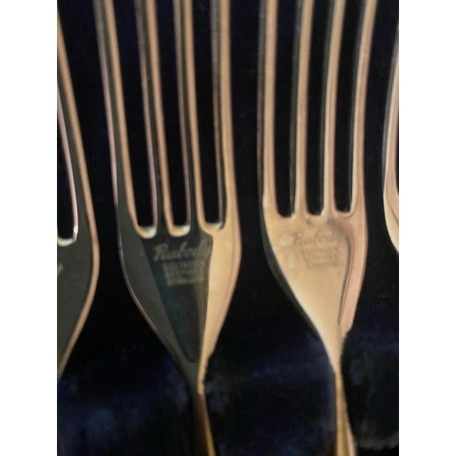 Waltcraft Cutlery set of 12 pieces featuring a black handles with rivet accents. The set includes both forks and knives...
