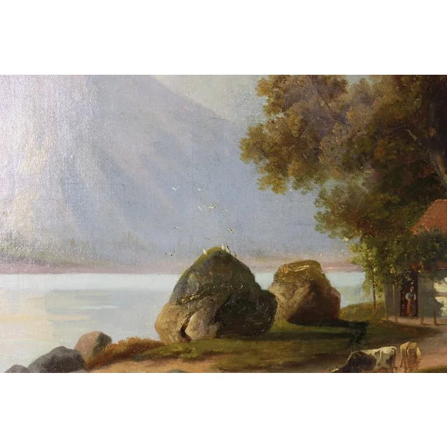 Oil on canvas representing a mountain landscape decorated with a lake and a herd of cows, signed at the bottom right not...