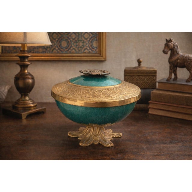 This elegant vintage pedestal bowl is crafted in brass with a rich green enameled body, produced in Israel circa the 1960s...