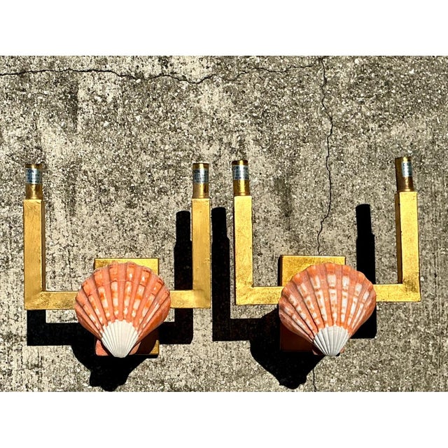 This pair of vintage wall sconces presents a compelling juxtaposition of organic and industrial design elements, pairing...