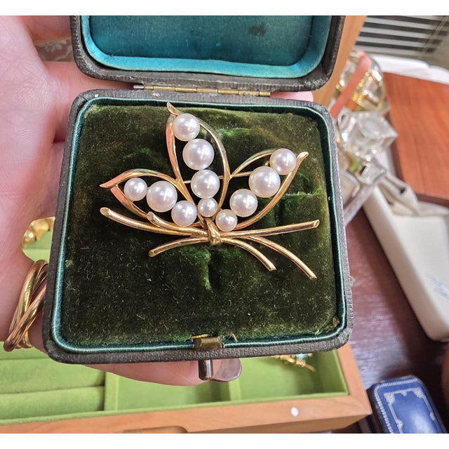 Vintage Mikimoto Akoya Pearl Lotus Brooch Circa 1970s This elegant vintage brooch by Mikimoto, is beautifully designed in...