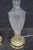 Pair of cut to clear crystal table lamps with etched detail throughout the bodies. Each lamp features a tapered form with...