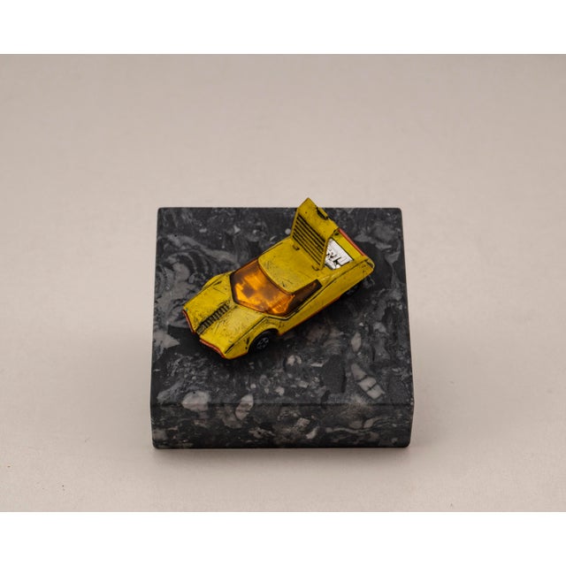 Original vintage die cast model of the datsun 126 x from matchbox, series no. 33, mounted on a solid marble base. A...