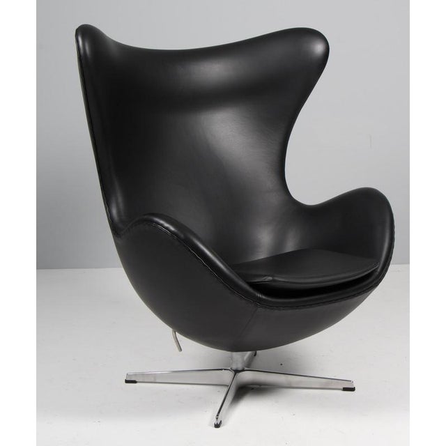 Arne Jacobsen lounge chair model Egg. Original upholstered with black semi aniline leatherleather. Four star base. with...