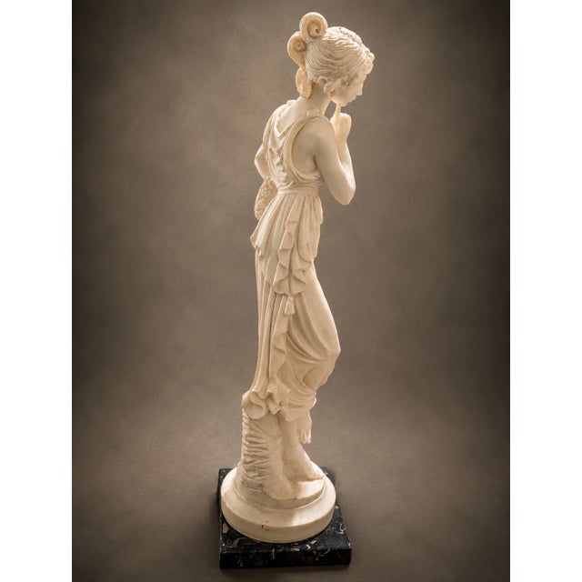 Embrace timeless elegance with this Vintage Neoclassical Maiden Sculpture. Standing at 17 inches, this stunning classical...