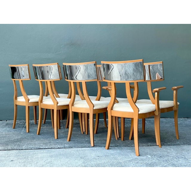This exceptional set of eight dining chairs is a masterful Italian Postmodern reimagining of the classical Greek Klismos...