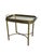 A brass faux bamboo tray table of the Hollywood Regency period, comprising a removable glass-inset tray top with canted...