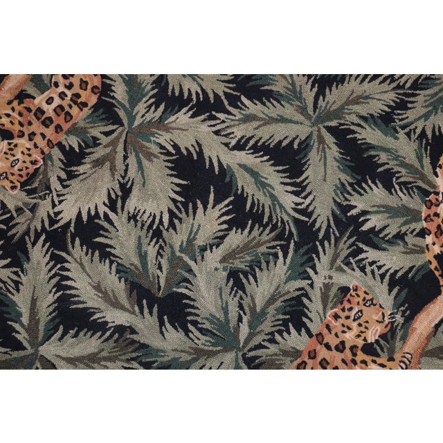 A late 20th century one of a kind Hooked Rug with 10 cheetahs on a 4 long branches on a green and black large leaf pattern...