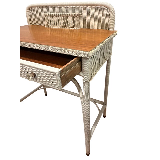 Lovely, vintage white wicker and wood top writing desk with drawer and glass knobs.