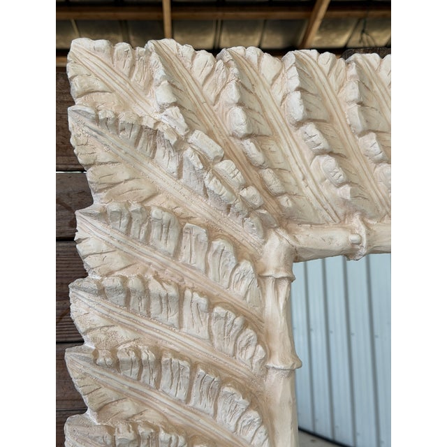 A truly monumental sculptural mirror featuring an all-over palm frond motif in high-relief plaster. The frame is richly...