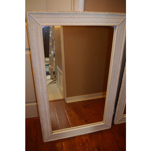 Vintage White Wicker Framed Mirrors. Very good condition. Some wear of the paint job of the sides of the framing. Made in...