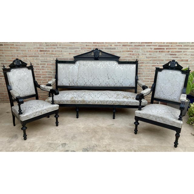 Set of Alphonsine Armchairs in ebonized wood, ca.1900. Back with pediment plume and shield inside. a style that stood out...