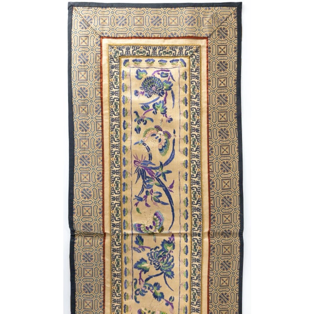 We are selling this nice Chinese silk textile embroidered robe sleeve with flower and butterfly decoration, probably 19th...