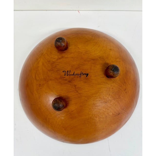 Vintage wooden bowl with hand-painted pinecone and evergreen branch decoration along the interior rim. Features a warm...