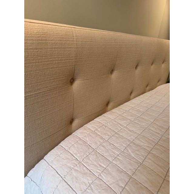 Queen bed frame in a beige / taupe weave fabric with headboard. Modern, low-profile, upholstered platform bed with inset...