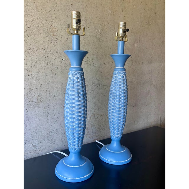 A stylish pair of vintage table lamps featuring a sculptural basket weave motif in a vibrant powder blue finish. Their...