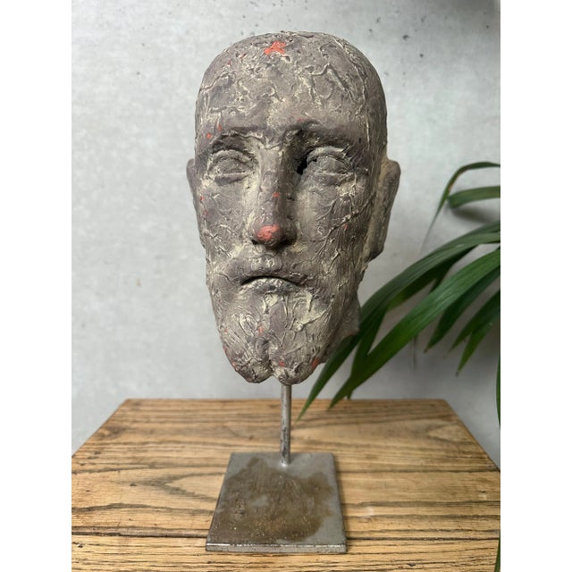 Terracotta male head on a metal stand. Signed "Col.H.D.V. …" and numbered. We cannot determine the maker of this...