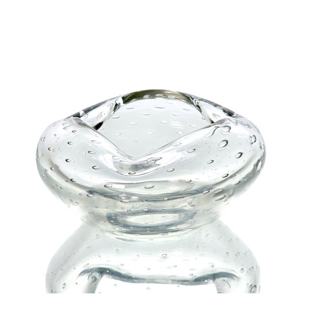 A sculptural Mid-Century Italian art glass ashtray crafted in the bullicante technique, featuring suspended air bubbles...