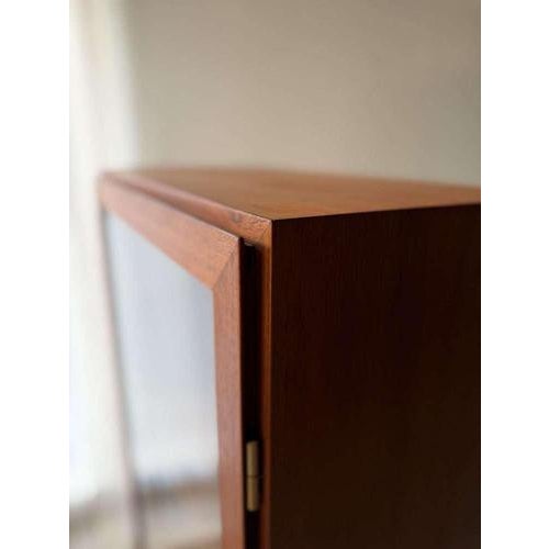 This 1960s teak display cabinet is a beautiful example of Danish modern design. Designed by Omann Jun for his eponymous...
