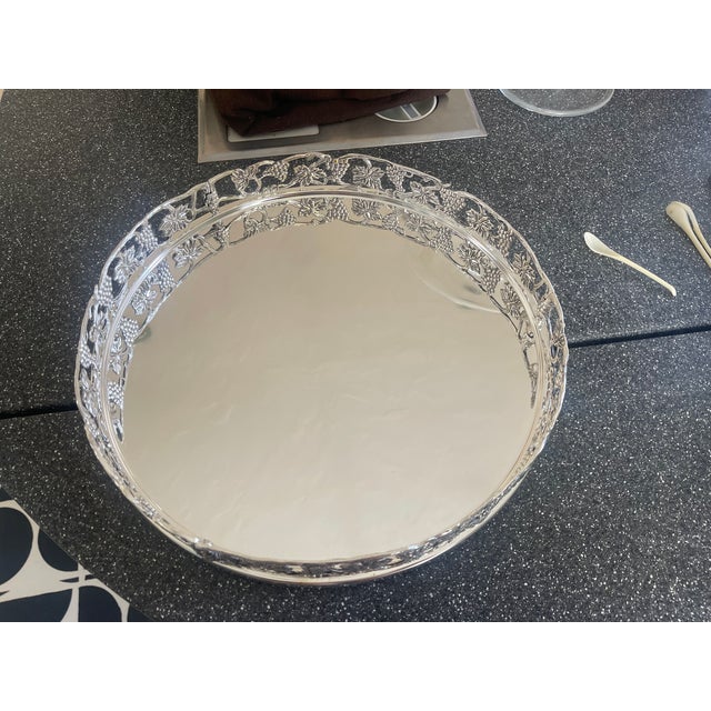 3-Tier Silver Etagere Trays With Grape Vine Motif. The etagere is missing the stand pieces that hold it together.