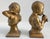 1950s Chalkware brother and sister figurine bookends with boy annoying his sister by playing his musical instrument....