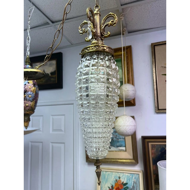 A fun pair of Hollywood regency cut glass and brass pendant style swag lights. These were probably hanging in a bathroom...