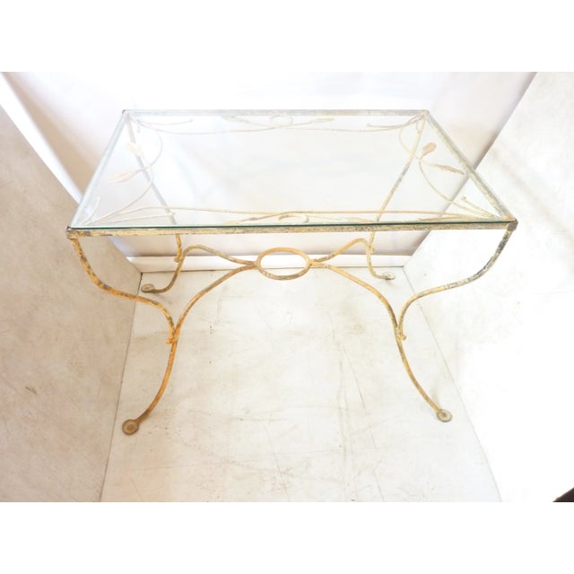 Mid-century iron garden table with beautiful weathered paint, new tempered glass top. Made in the mid 20th century.