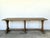 This vintage farm table exudes an authentic Old World charm, featuring a robust plank top and a striking triple trestle...