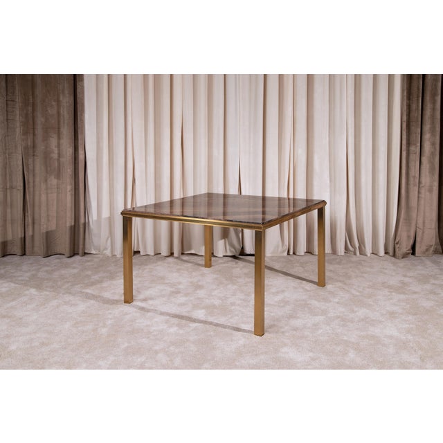 Elegant brass and marble table of Italian production, 1980s. The grain and color of the marble, very particular and...