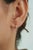 These Tiny Diamond Huggie Hoop Earrings feature 0.15 carats of natural diamonds set in 18K Yellow Gold. Each diamond...