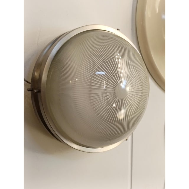 The “Sigma” wall lamp in nickel-plated brass and pressed glass, designed by Sergio Mazza in the 1960s for Artemide. The...