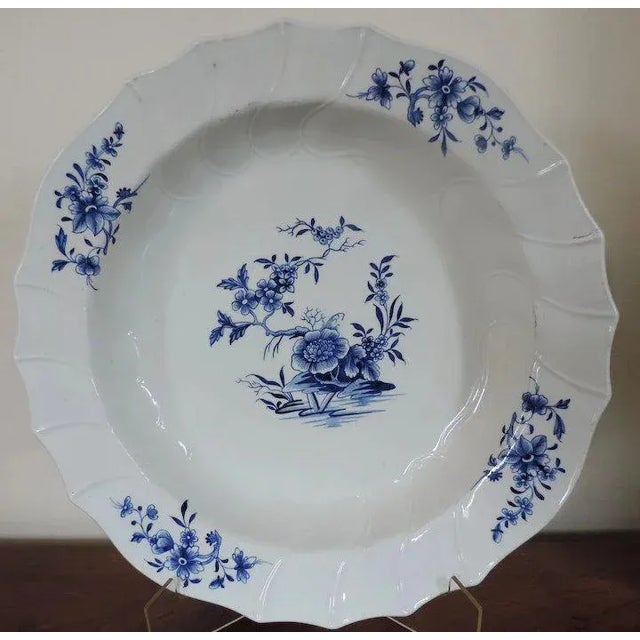 Large 18th c. continental blue & white porcelain charger decorated with flowering shrubs rising from rockwork and floral...