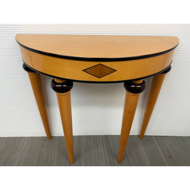 Design Plus Gallery presents an Art Deco Style Demi-lune Table from Bombay Company. The table has a mahogany trim flanking...