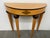 Design Plus Gallery presents an Art Deco Style Demi-lune Table from Bombay Company. The table has a mahogany trim flanking...