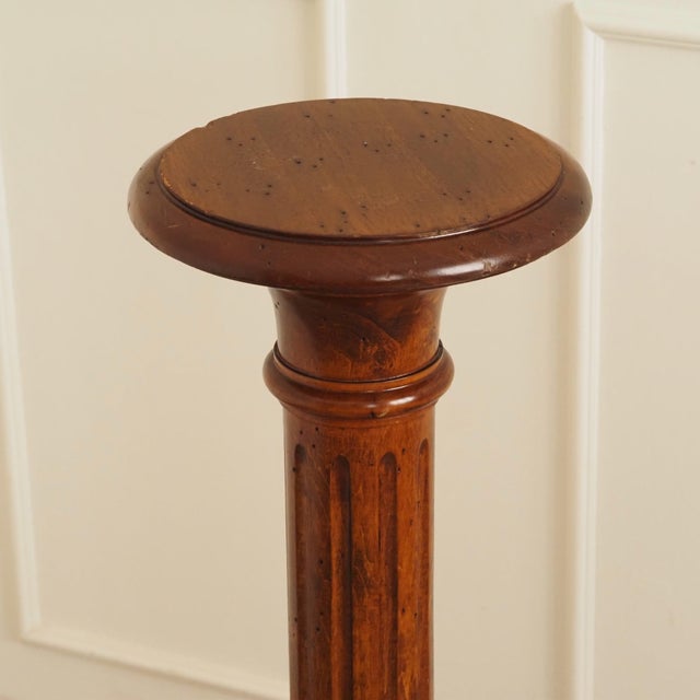 A column-shaped wooden stand from the Wilhelminian era, dating from around 1870–1890, crafted from solid hardwood with a...