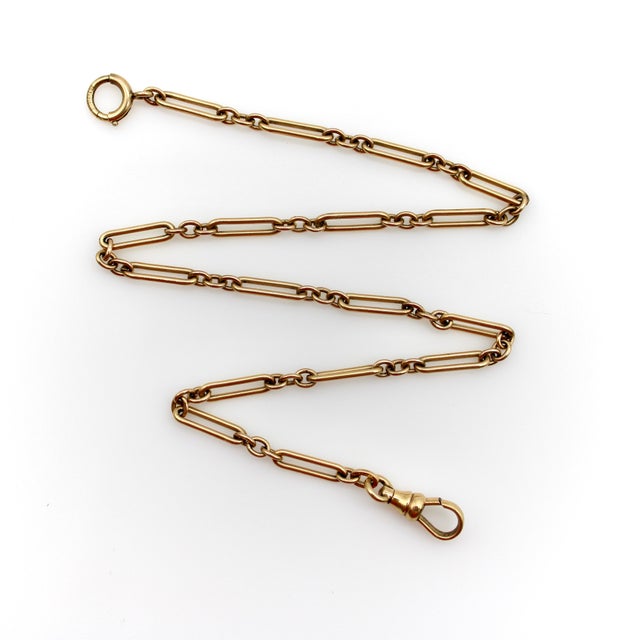 This is a beautiful Art Deco pocket watch chain that consists of paper clip links alternating between a row of three...