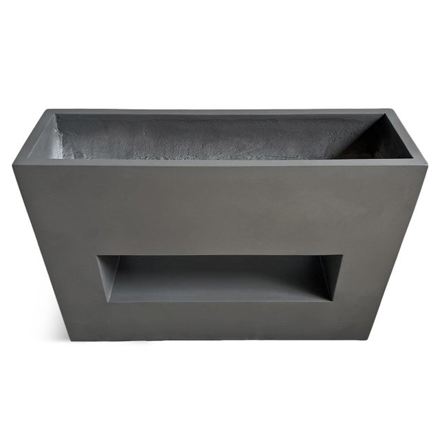 Modern architectural planter featuring a clean geometric silhouette with open center detail. Suited for contemporary...