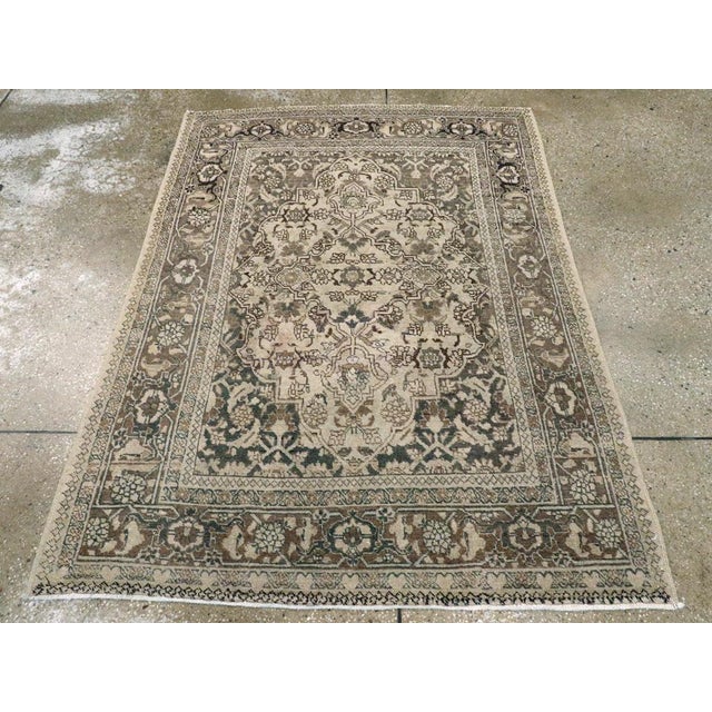 This Early 20th century Persian Tabriz rug, measuring 4' 1" x 5' 8", showcases the refined artistry and balanced elegance...