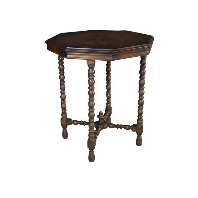 This antique Jacobean-style side table is a beautifully crafted wooden piece featuring a distinct octagonal top made from...