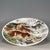 A striking Chinese porcelain charger (plate). The white ground is finely hand-painted with a dynamic scene of two fierce...