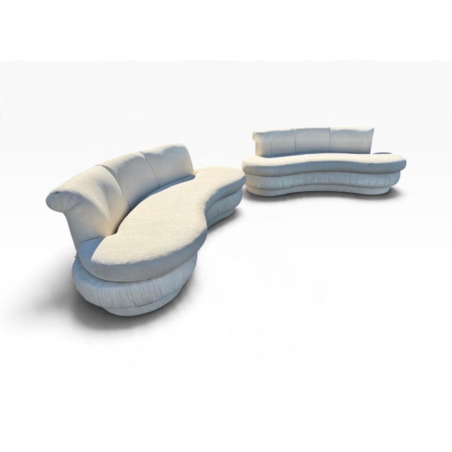 Make a bold statement with this stunning pair of Postmodern Sculptural Curved Kidney Cloud Sofas, dating to the 1990s....