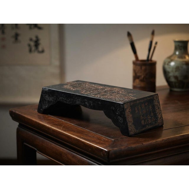 This Chinese ink composite piece features a dark, crackled lacquer finish adorned with finely carved and gilt-highlighted...