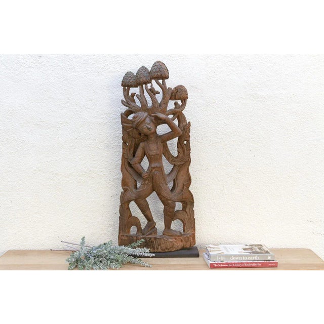 This exquisite hand-carved wood sculpture is a testament to the intricate artistry of Southeast Asian craftsmanship,...