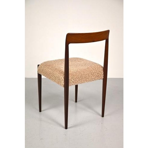 Vintage Lübke chair made of wood with a beautiful grain. This chair has been reupholstered with a modern fabric. Some...