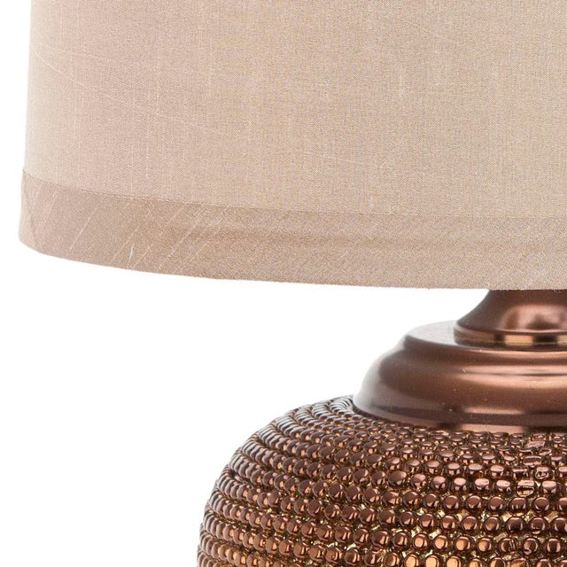 The shapely Gold Bead Lamp conjures images of a vintage Moroccan vessel crafted of hammered metal. The compressed round...