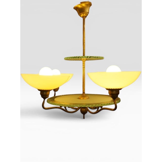 Four-armed brass chandelier, attributed to Harald Notini for Arvid Böhlmarks Lampfabrik, Sweden, ca. 1927–1933. A rare...