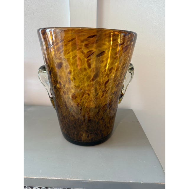 Stunning blown glass champagne bucket in browns and golds reminiscent of a leopard print. The quality of the piece is seen...