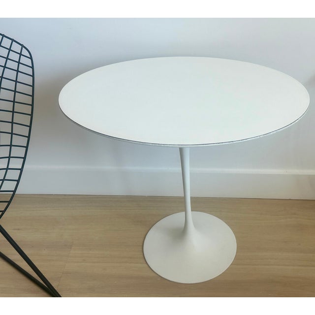 Oval Tulip side or end table designed by Eero Saarinen for Knoll in 1956, rare early bow-tie label. Beveled white laminate...