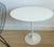 Oval Tulip side or end table designed by Eero Saarinen for Knoll in 1956, rare early bow-tie label. Beveled white laminate...